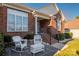 Front porch with white rocking chairs and a table at 7457 Waterleaf Ct, Stanley, NC 28164