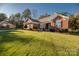 Brick house with front porch and manicured lawn at 7457 Waterleaf Ct, Stanley, NC 28164