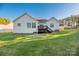 Rear view of house, showcasing deck and yard at 7457 Waterleaf Ct, Stanley, NC 28164