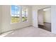 Bright bedroom with large windows offering scenic views, plush carpeting, and access to an adjacent room at 1034 Heath Helms Rd, Monroe, NC 28110