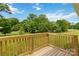 Wood deck overlooking green lawn with lush trees in the background under blue sky at 1034 Heath Helms Rd, Monroe, NC 28110