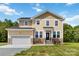 Charming two-story home with stone accents, a well-manicured lawn, and an attached two-car garage at 1034 Heath Helms Rd, Monroe, NC 28110