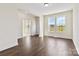 Inviting living room featuring rich hardwood floors, bright windows, and an open layout for flexible living at 1034 Heath Helms Rd, Monroe, NC 28110