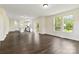 Open-concept living area with hardwood floors, large windows, and a view into the modern kitchen at 1034 Heath Helms Rd, Monroe, NC 28110