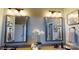 Double vanity bathroom with large mirrors and decorative accents at 112 Noah Ln, Troutman, NC 28166
