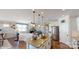 Open concept kitchen with island, stainless steel appliances, and adjacent living room at 112 Noah Ln, Troutman, NC 28166