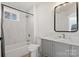 Updated bathroom with gray vanity, marble tile, and bathtub at 216 St Michael Ave, Great Falls, SC 29055