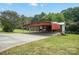 Red metal carport provides covered parking at 504 15Th Se Ave, Hickory, NC 28602