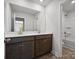 Modern bathroom featuring a double sink vanity, a large mirror, and a shower-tub combination at 1051 Bull Dog Ln, Wingate, NC 28174