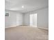 Large carpeted bonus room with a window, white trim, and open access to other rooms at 1051 Bull Dog Ln, Wingate, NC 28174