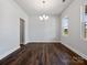 Light-filled dining room featuring a modern chandelier and hardwood floors at 1051 Bull Dog Ln, Wingate, NC 28174