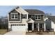 Two-story home with attached garage, neutral siding, and well-manicured front yard at 1051 Bull Dog Ln, Wingate, NC 28174