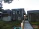 Exterior view of a home with a ramp leading to the entrance and a shed, providing accessibility and storage solutions at 112 S Cardinal Dr, New London, NC 28127