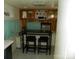Compact kitchen area featuring a bar-height table with stools and ample cabinet space at 112 S Cardinal Dr, New London, NC 28127