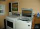 Convenient laundry room featuring a washer and dryer, with shelving for storage and organization at 112 S Cardinal Dr, New London, NC 28127