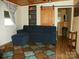 Cozy living room featuring a comfortable blue sectional sofa, stylish rug, and natural light at 112 S Cardinal Dr, New London, NC 28127