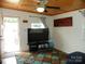 Bright living room with a large TV, decorative curtains, and a welcoming atmosphere at 112 S Cardinal Dr, New London, NC 28127