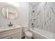 Bathroom with marble-style tile, a bathtub, and a modern vanity at 312 General As Johnston St, Stanley, NC 28164