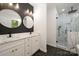 Spa-like bathroom with a walk-in shower, double vanity, and marble tile at 312 General As Johnston St, Stanley, NC 28164