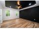 Bedroom with dark accent wall and light hardwood floors at 312 General As Johnston St, Stanley, NC 28164