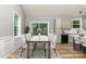 Virtually staged dining room features a large wooden table and six chairs at 312 General As Johnston St, Stanley, NC 28164