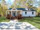 White house with front porch, wooden stairs, and landscaped yard at 312 General As Johnston St, Stanley, NC 28164