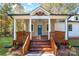 Inviting front porch with wooden railings and steps leading to the home's entrance at 312 General As Johnston St, Stanley, NC 28164