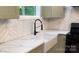 White farmhouse sink with marble countertop and herringbone backsplash at 312 General As Johnston St, Stanley, NC 28164