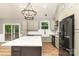 Modern kitchen with a farmhouse sink and stainless steel appliances at 312 General As Johnston St, Stanley, NC 28164