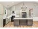 Modern kitchen with light green cabinets, marble countertops, and a large island at 312 General As Johnston St, Stanley, NC 28164