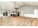 Open living room with high ceilings, hardwood floors, and a kitchen island at 312 General As Johnston St, Stanley, NC 28164