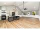 Open living room with high ceilings, hardwood floors, and a kitchen island at 312 General As Johnston St, Stanley, NC 28164