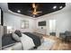 Virtually staged main bedroom with a gray bed and a dark accent wall at 312 General As Johnston St, Stanley, NC 28164