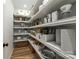 Well-organized pantry featuring shelving with food storage containers, baskets, and kitchenware items at 312 General As Johnston St, Stanley, NC 28164