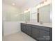 Modern bathroom with double vanity and walk-in shower at 1010 Lowland Way, Waxhaw, NC 28173