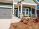 Charming front porch with yellow bench and landscaping at 1010 Lowland Way, Waxhaw, NC 28173