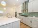 Modern kitchen with white cabinets, quartz countertops and stainless steel appliances at 1010 Lowland Way, Waxhaw, NC 28173