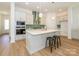 Modern kitchen with white cabinets, quartz countertops, and stainless steel appliances at 1010 Lowland Way, Waxhaw, NC 28173