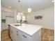 Modern kitchen island with quartz countertop and gold fixtures at 1010 Lowland Way, Waxhaw, NC 28173