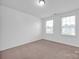 Well-lit bedroom with neutral walls and carpet at 129 Eden Ave, Mooresville, NC 28115