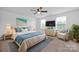 Main bedroom with ceiling fan and large TV at 129 Eden Ave, Mooresville, NC 28115