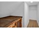 Small attic closet with wooden shelving and hanging rod at 129 Eden Ave, Mooresville, NC 28115