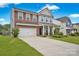 Two-story brick home with a two-car garage and landscaped yard at 129 Eden Ave, Mooresville, NC 28115