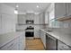 Gray kitchen with stainless steel appliances and island at 129 Eden Ave, Mooresville, NC 28115