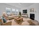 Living room features fireplace, light colored couch, and wooden coffee table at 129 Eden Ave, Mooresville, NC 28115