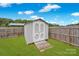 White storage shed with wooden ramp at 129 Eden Ave, Mooresville, NC 28115