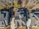 An aerial view of a lovely gray roofed home with a winding driveway and lush, tree-filled surroundings at 2257 Tatton Hall Rd, Fort Mill, SC 29715