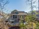 Back exterior view of a brick home with a screened patio and mature trees at 2257 Tatton Hall Rd, Fort Mill, SC 29715