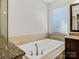 Close-up of bathtub with tile surround and brushed nickel hardware at 2257 Tatton Hall Rd, Fort Mill, SC 29715