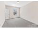 Bedroom with neutral carpet, double door closet, and a window for natural light at 2257 Tatton Hall Rd, Fort Mill, SC 29715